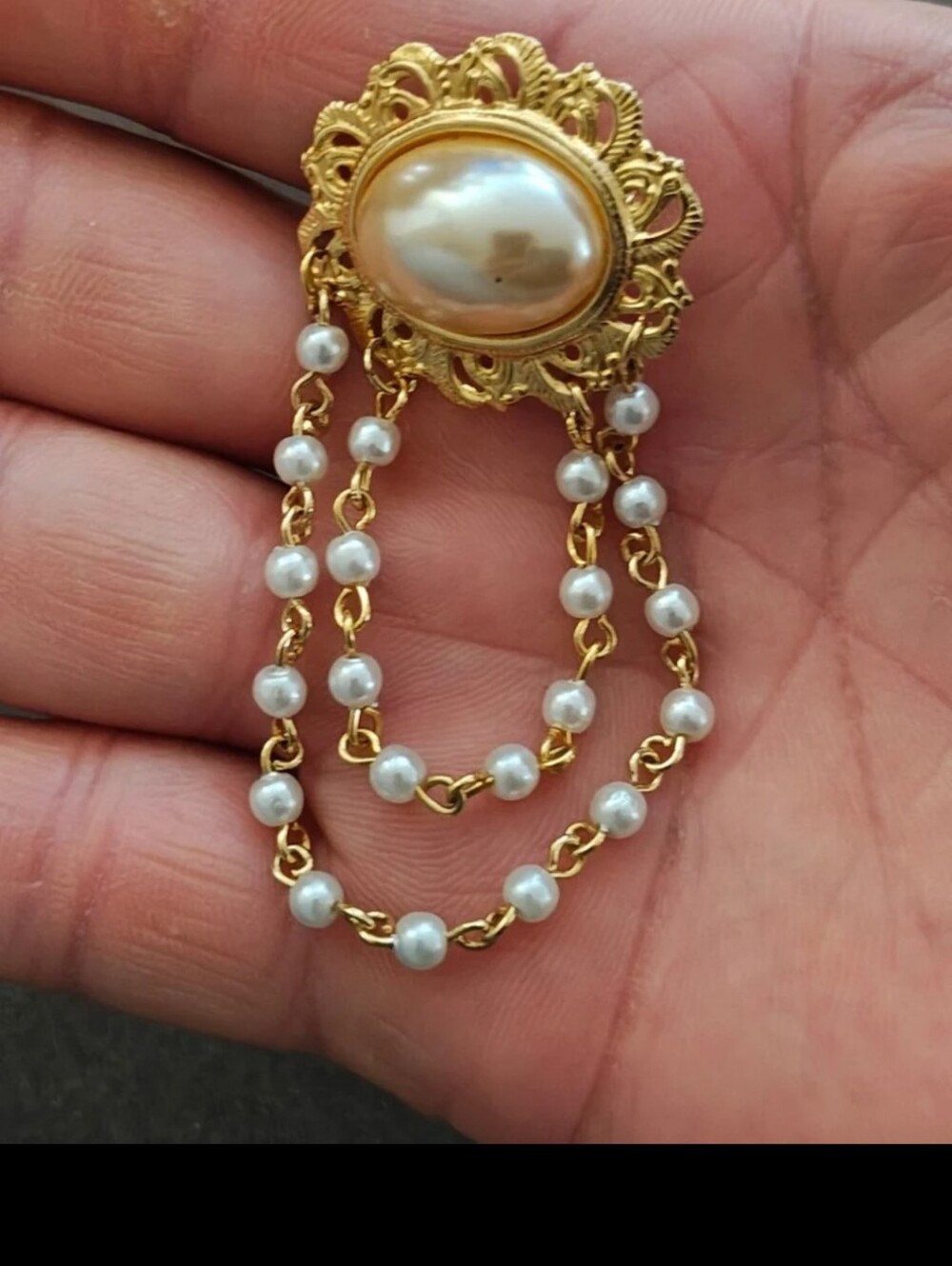 1980s Gold Tone Filigree Chatelaine Brooch With a Center Faux Pearl.